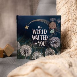 The World Waited For You You, New Baby Gift Book, on blanket with wooden blocks.