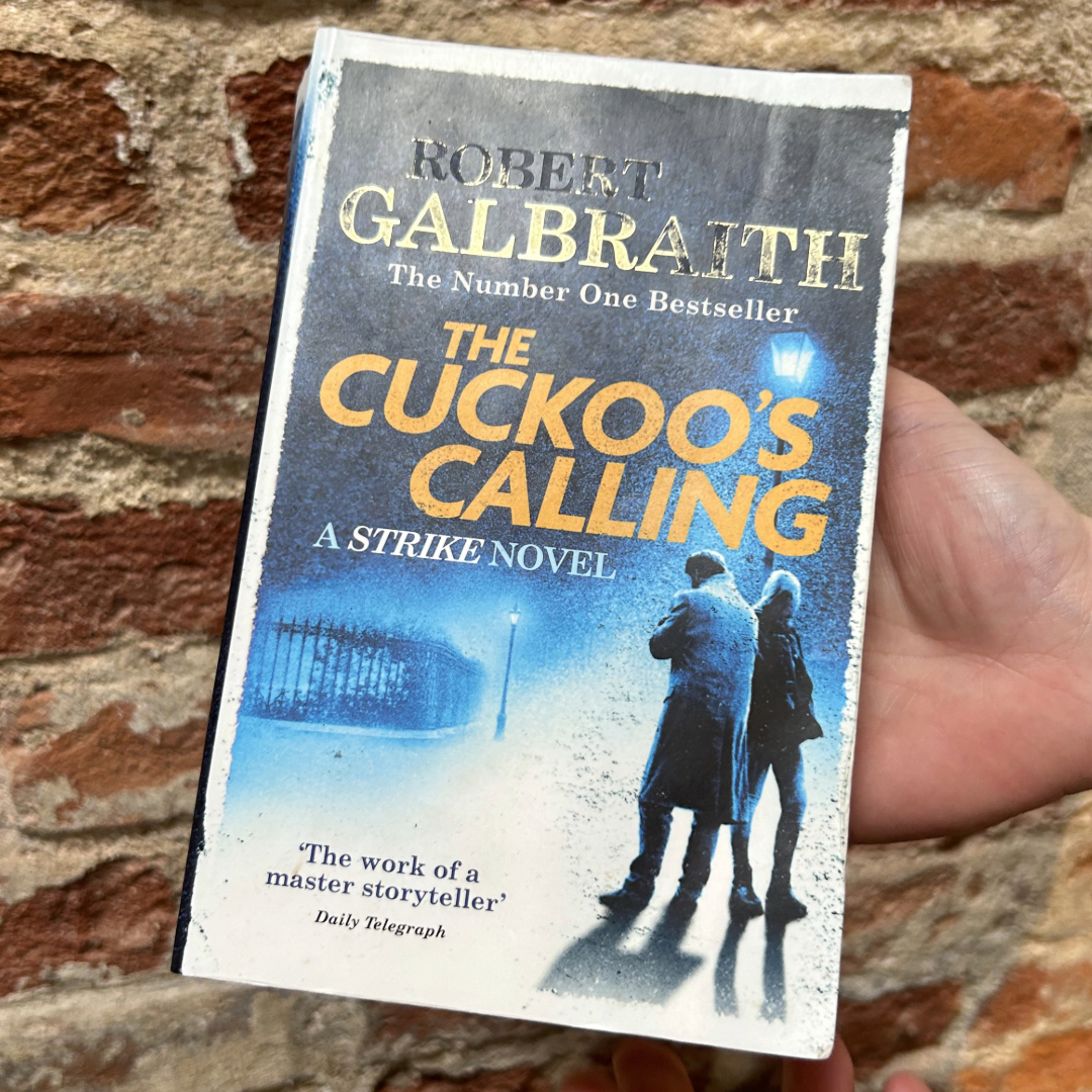 James holding his top reads of 2024 - The Cuckoo's Calling