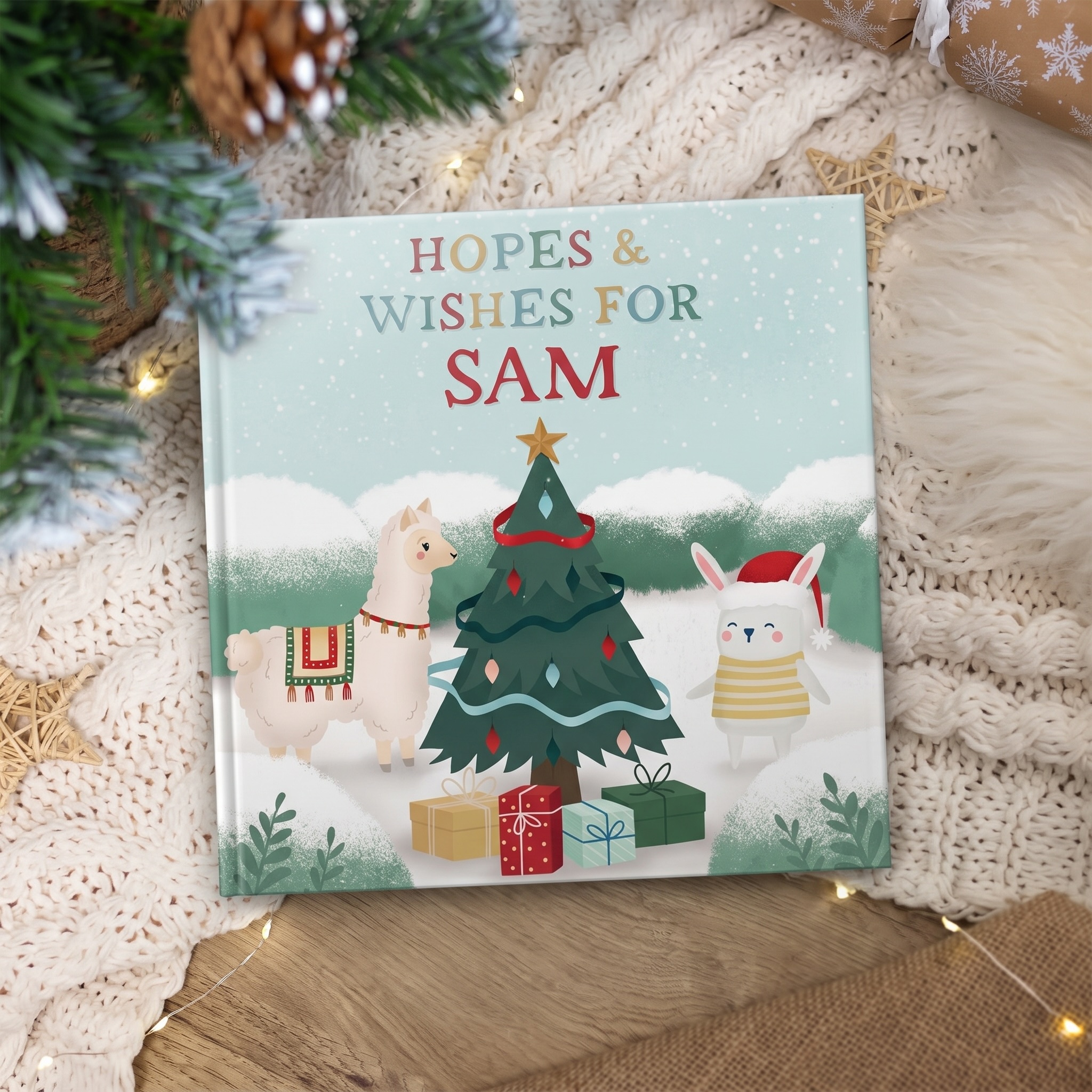 Personalised hopes and wishes for Sam book, featuring a, llama and a little bunny wearing a santa hat surrounding a Christmas tree with presents.